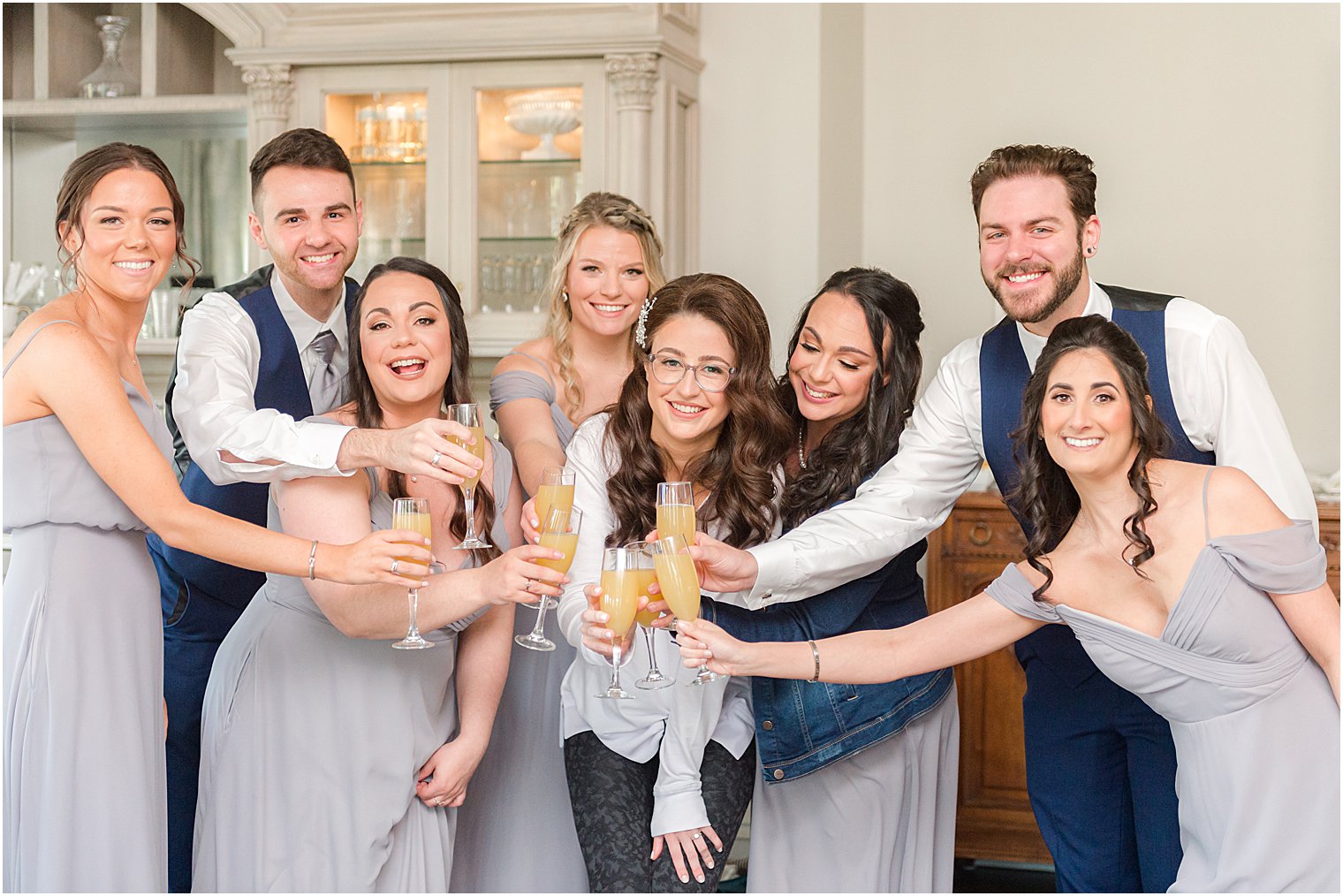 bride toasts mimosas with bridal party in suite at Park Chateau Estate and Gardens