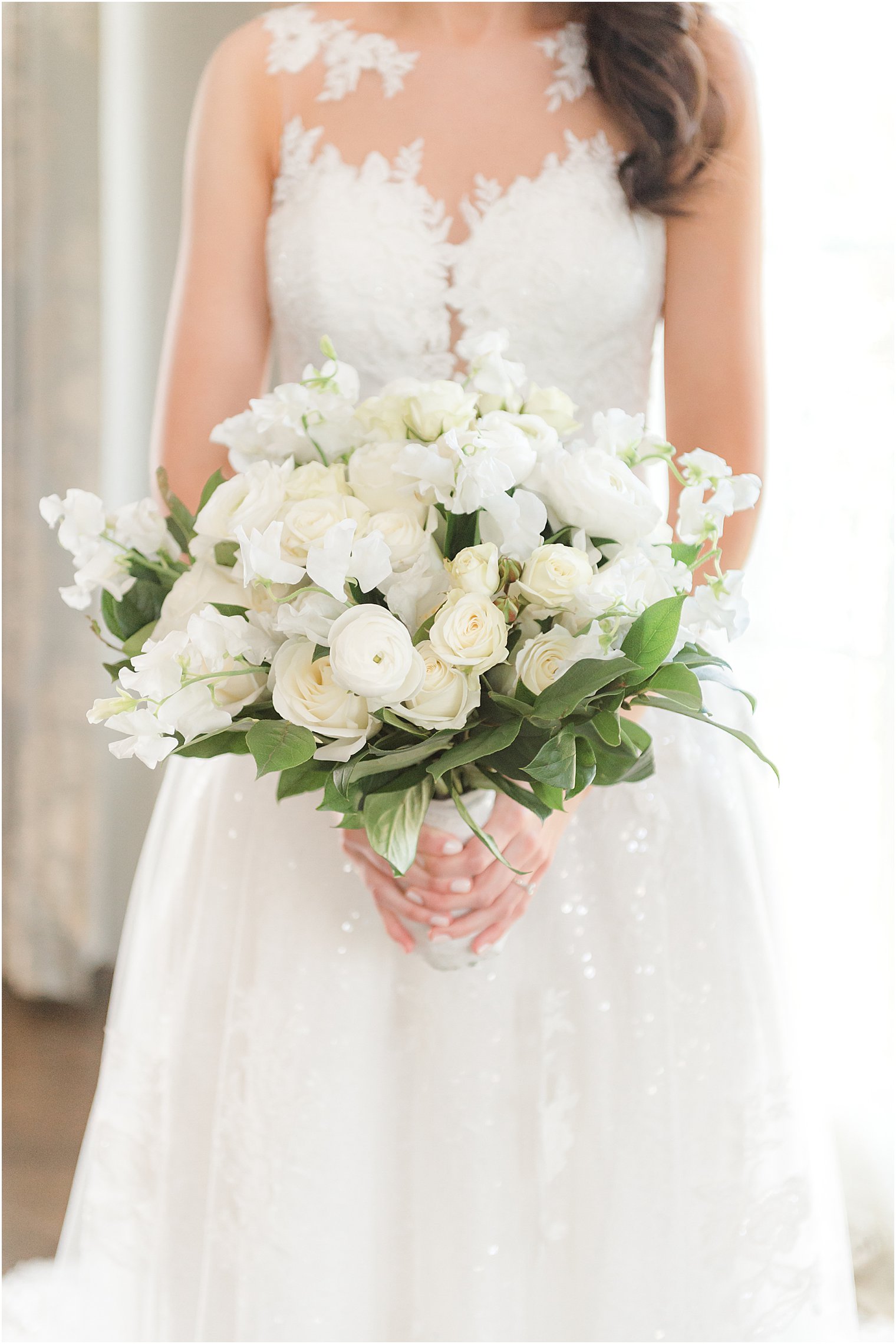 bride holds bouquet white roses 