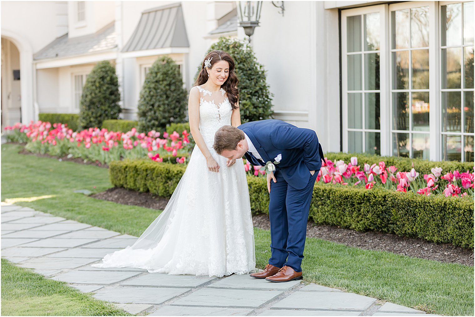 groom leans over smiling at bride during first look at Park Chateau Estate and Gardens