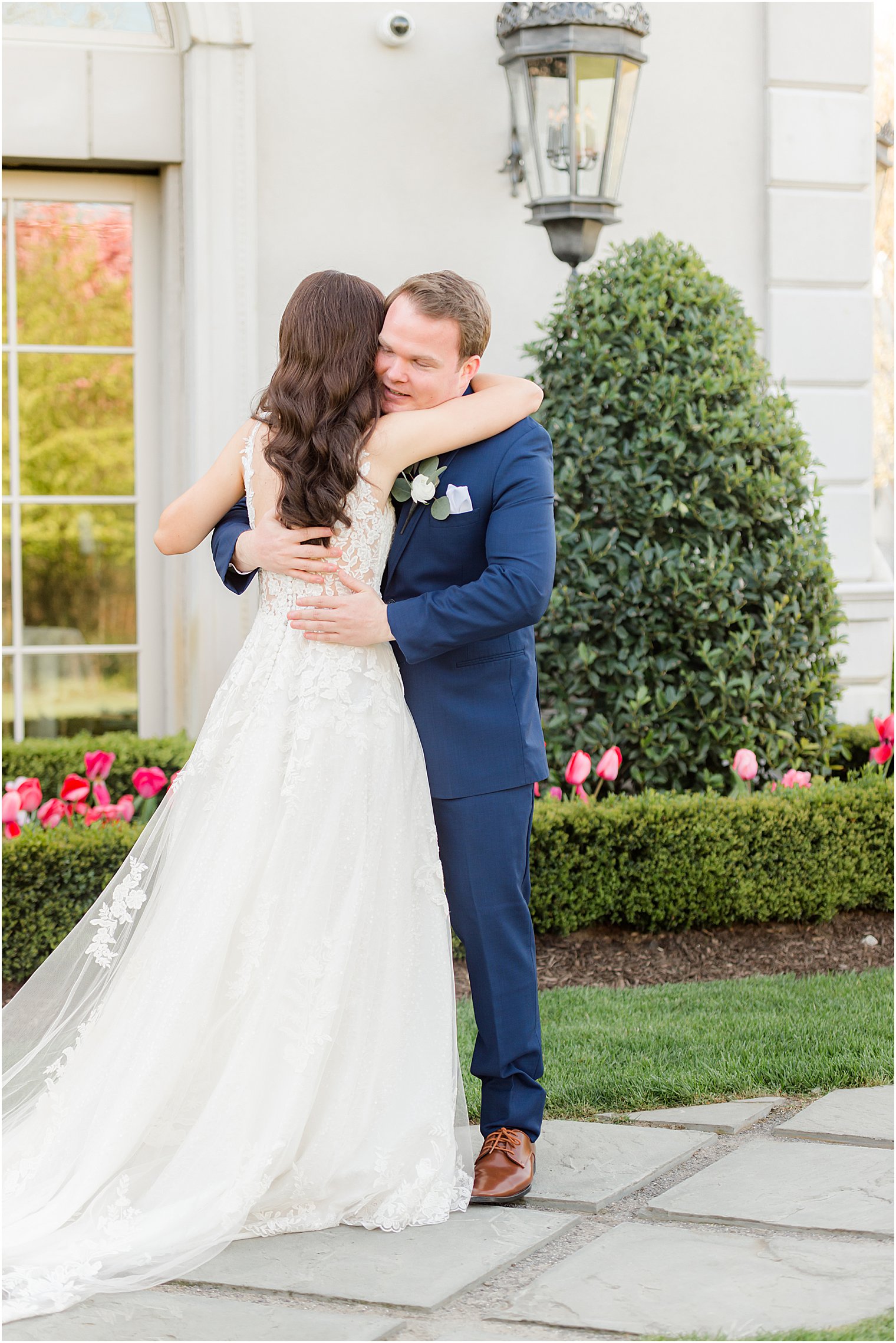bride and groom hug during first look at Park Chateau Estate and Gardens