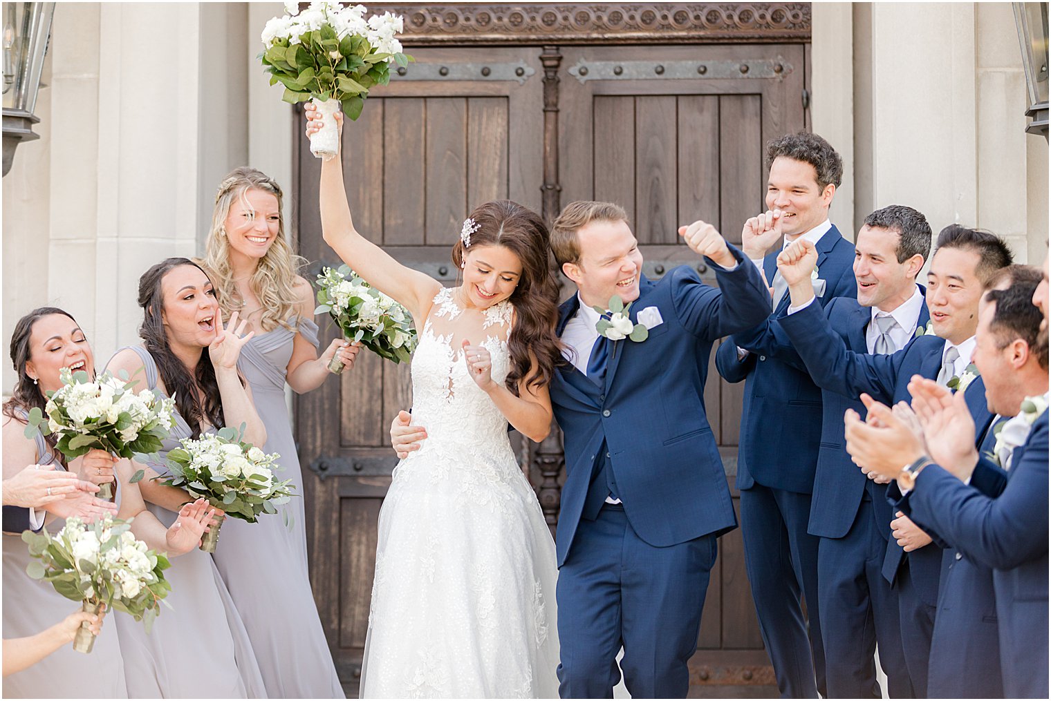 newlyweds cheer with wedding party clapping outside the chapel at Park Chateau Estate and Gardens