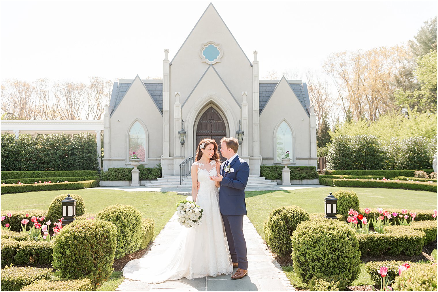 bride and groom stand together outside chapel at Park Chateau Estate