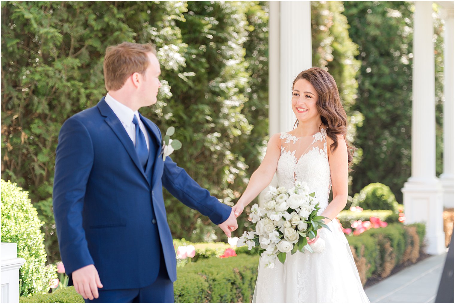 groom leads bride under awning at Park Chateau Estate