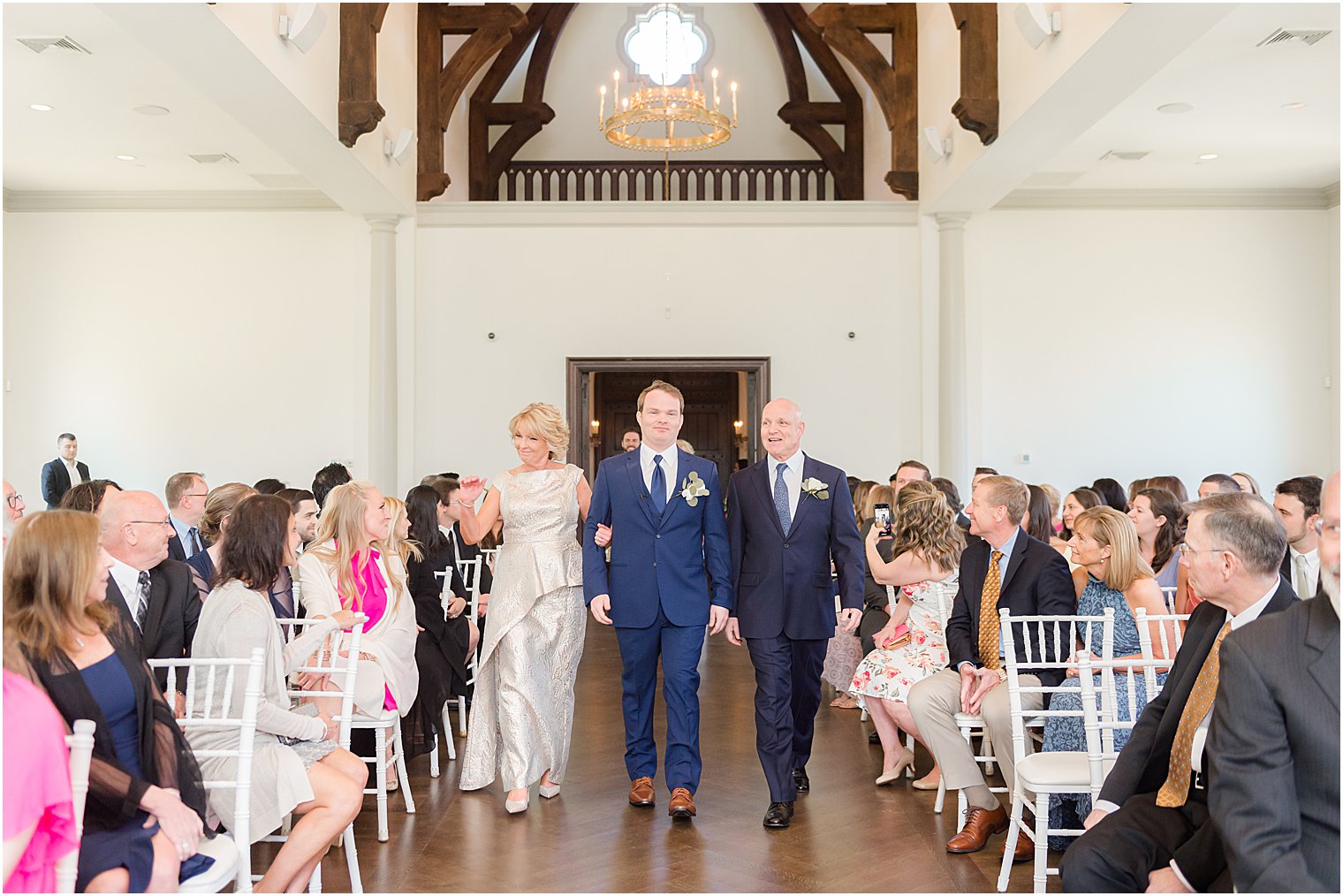 groom walks down aisle with parents at Park Chateau Estate