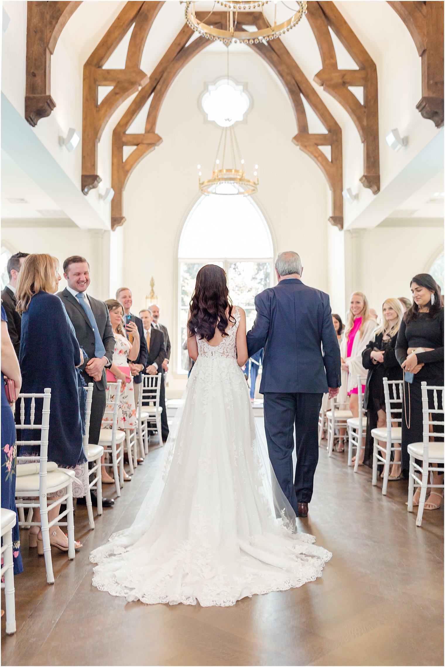 bride walks down aisle of wedding ceremony in chapel at Park Chateau Estate