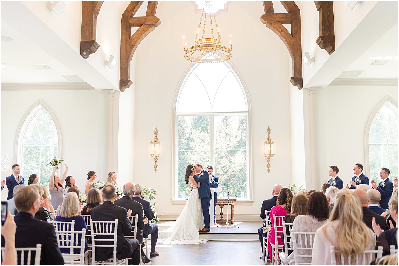 newlyweds kiss during wedding ceremony in chapel at Park Chateau Estate