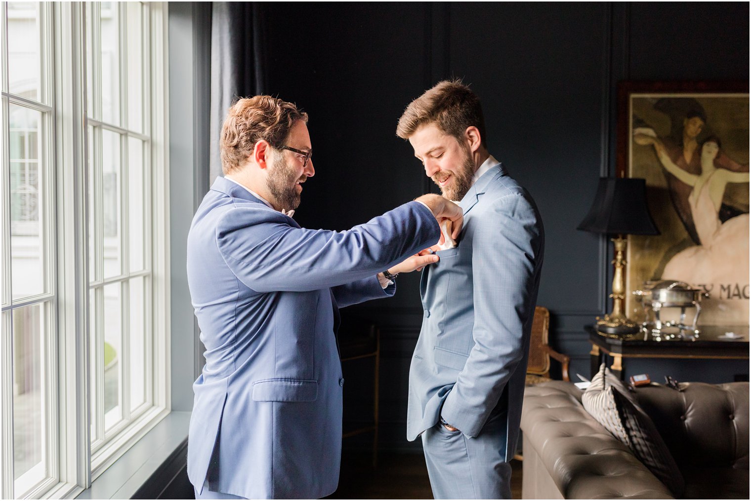 groomsman adjusts groom's pocket square during prep at Park Chateau Estate