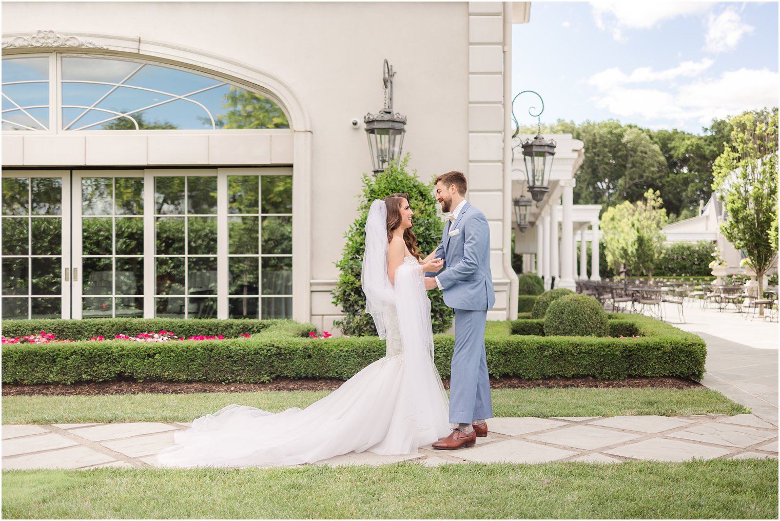 bride walks to groom for first look in courtyard at Park Chateau estate 