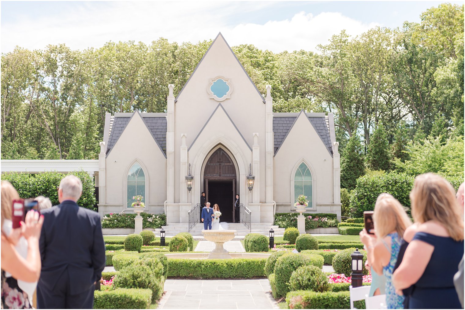 bride and father walk out of chapel doors at Park Chateau 