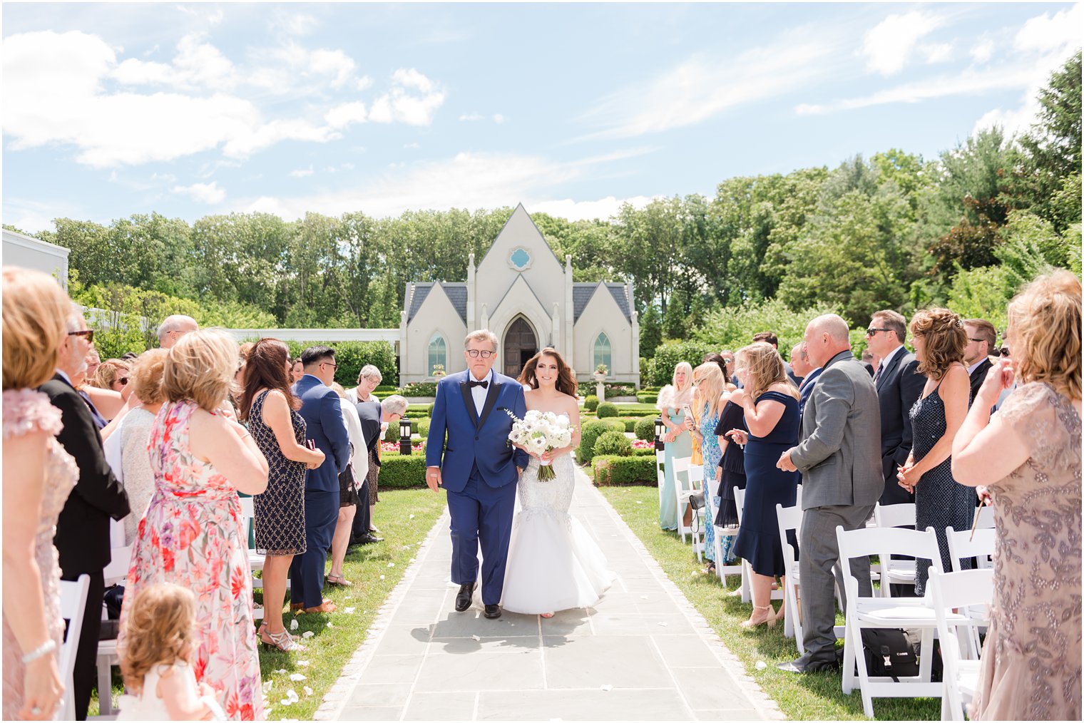 bride and father walk down aisle at Park Chateau garden ceremony 