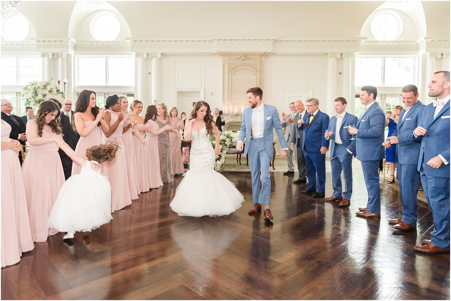 bride and groom dance between bridal party on floor in ballroom at Park Chateau Estate