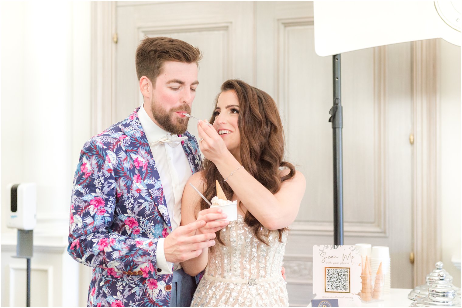 bride feeds groom in pink and blue jacket ice cream at Park Chateau