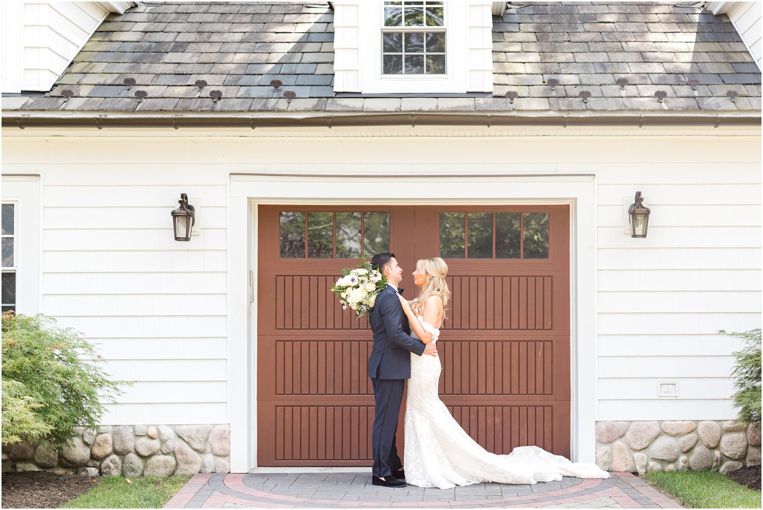 bride and groom hug by wooden door at The English Manor