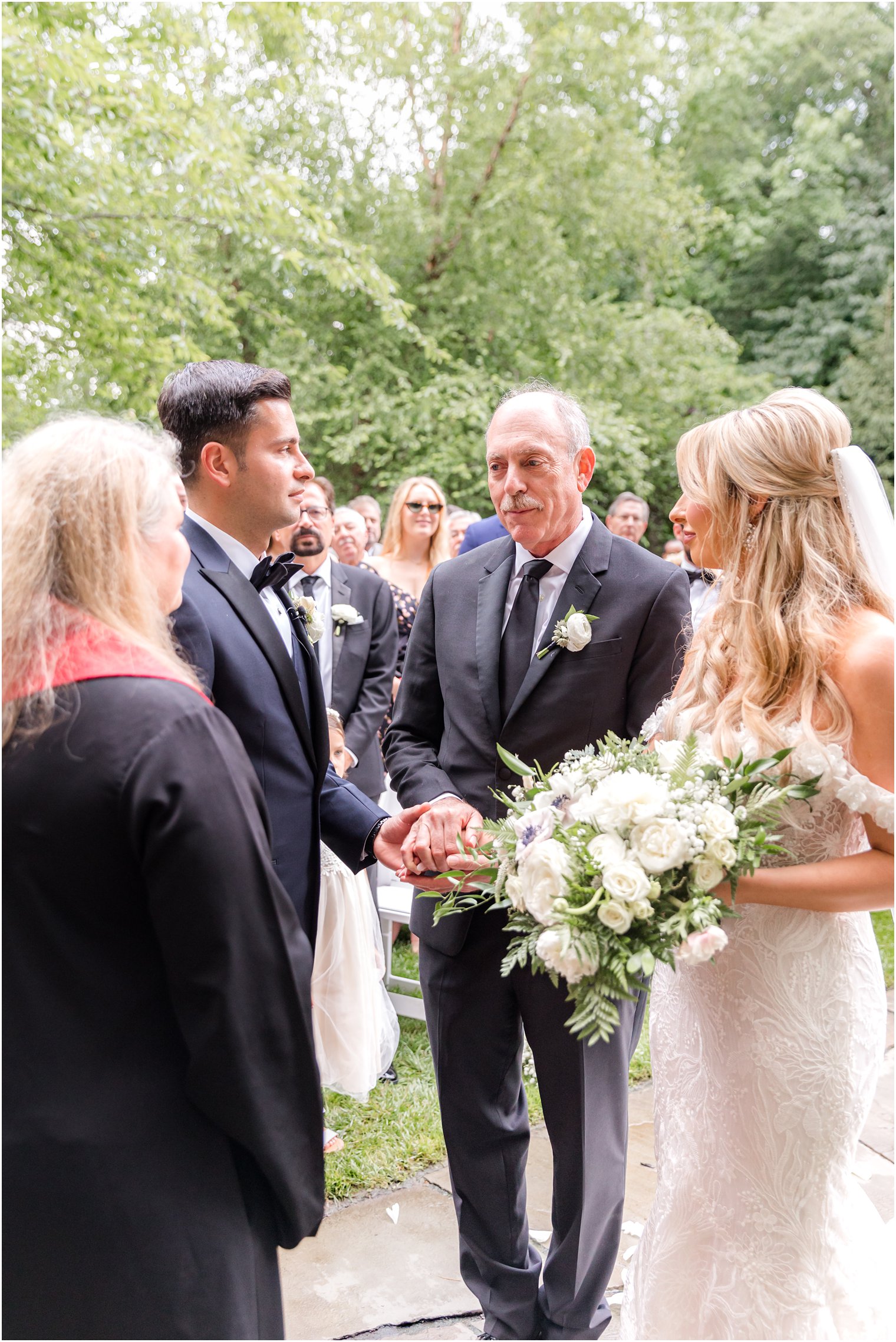 father gives bride away during wedding ceremony at The English Manor 