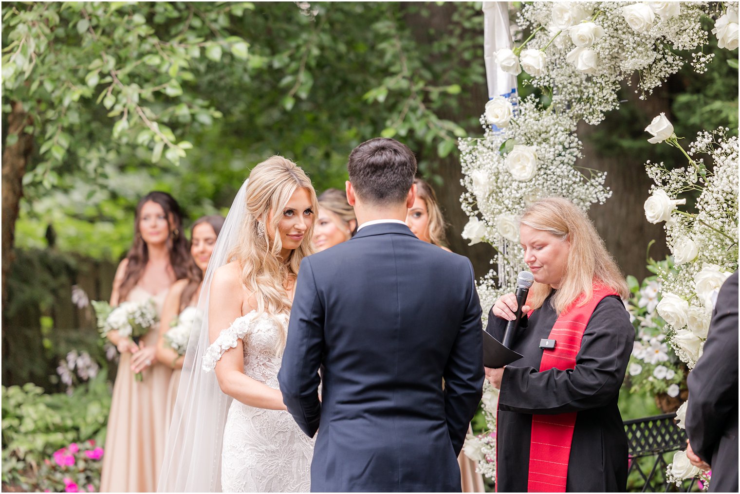 bride and groom exchange vows during garden style wedding at The English Manor