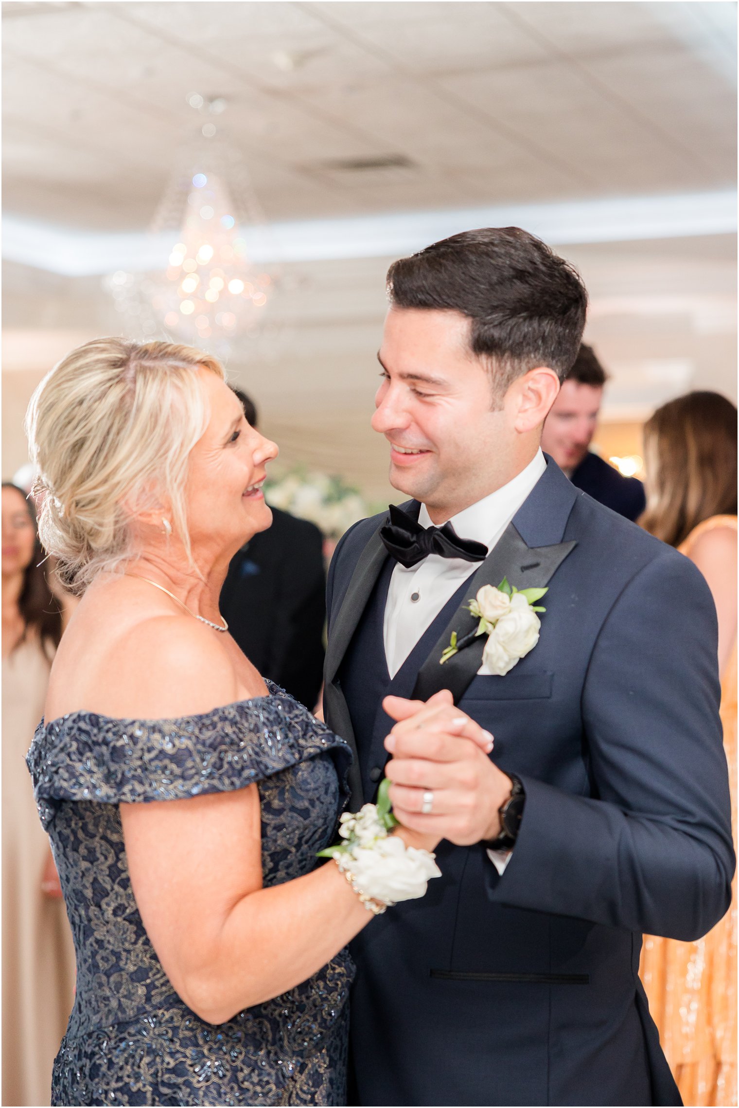 groom dances with mom during NJ wedding reception in ballroom 