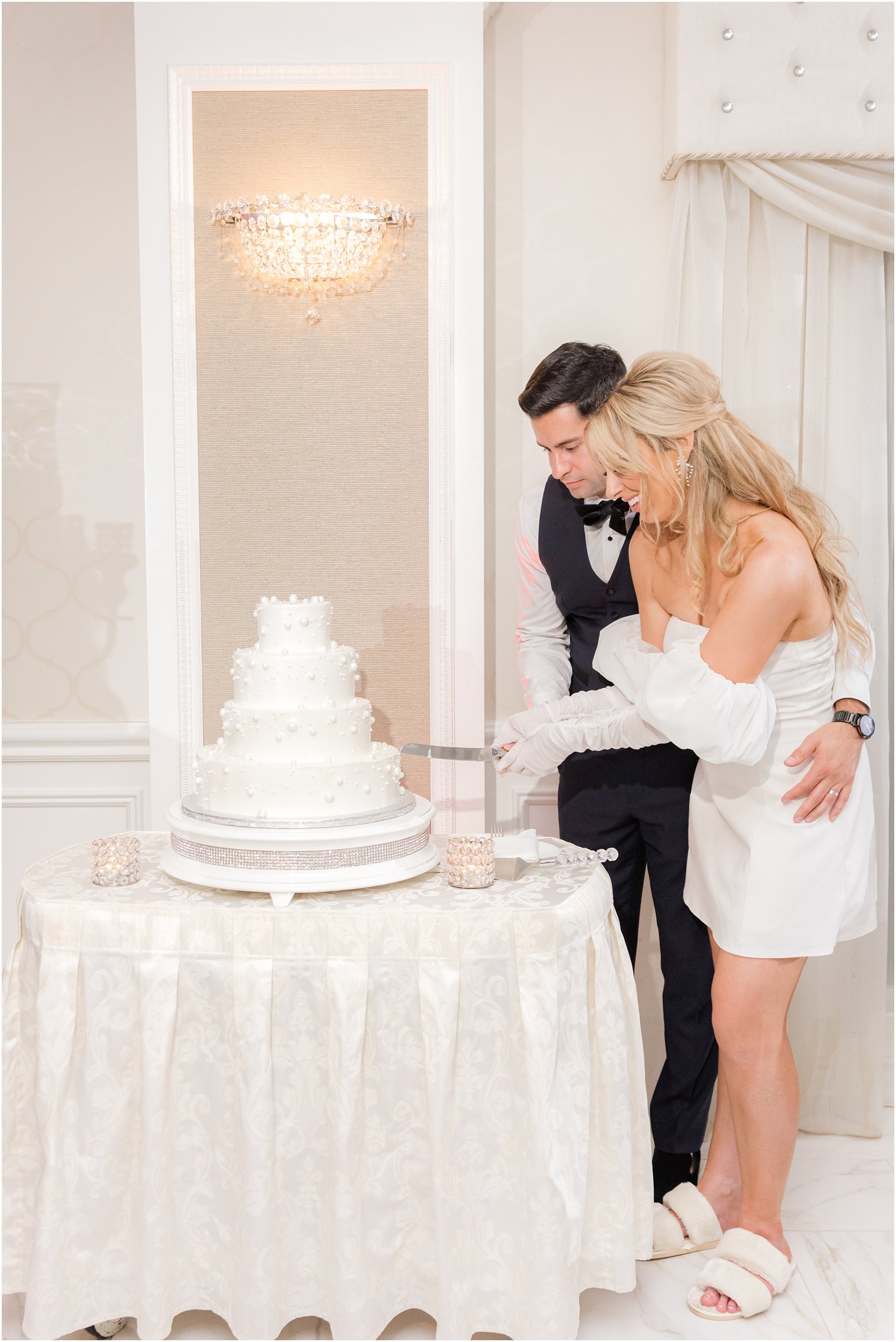 bride and groom cut wedding cake during Ocean NJ wedding reception 