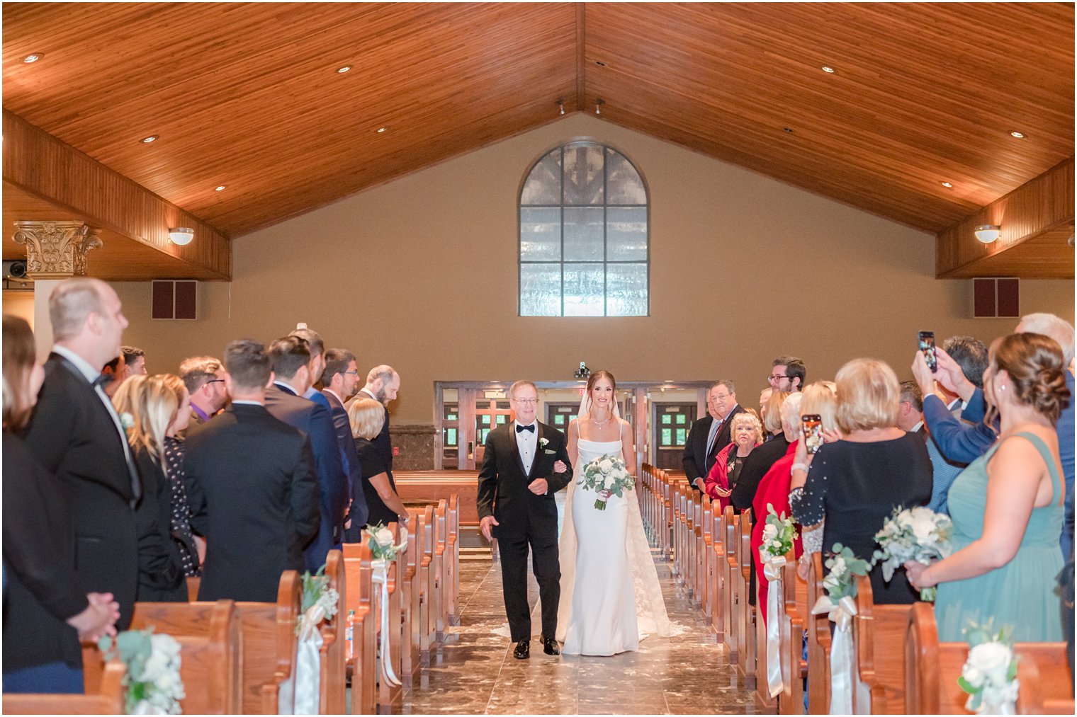 bride escorted by father walk down aisle for traditional church ceremony in small New Jersey church