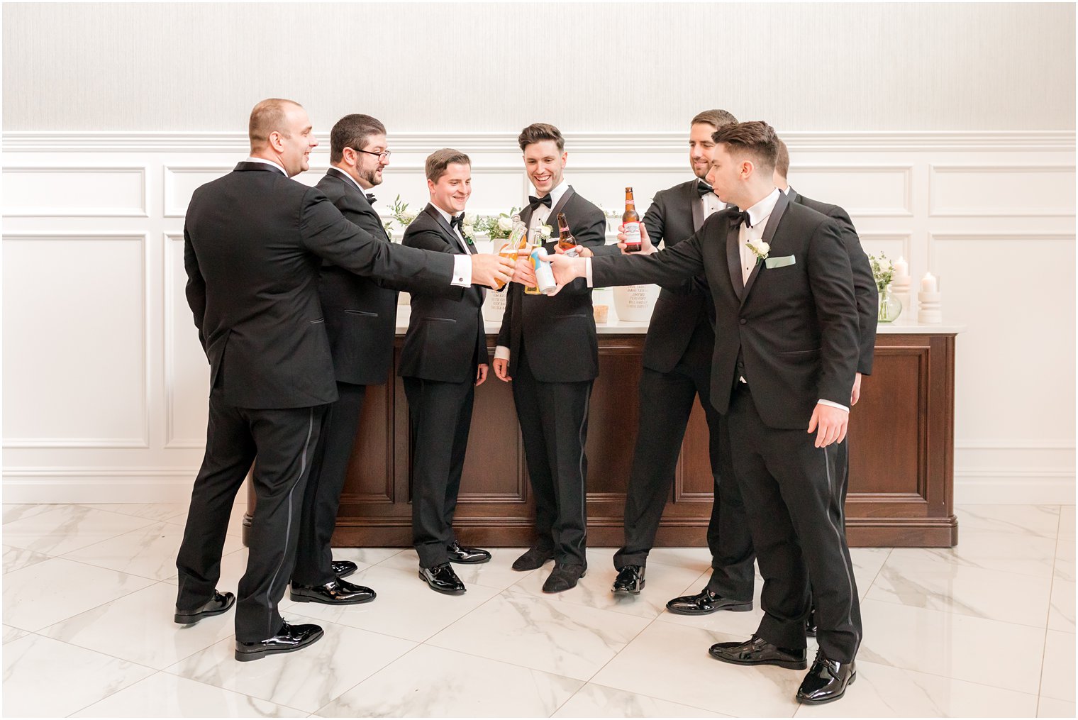 groom toasts beers with groomsmen before reception at The Mill Lakeside Manor