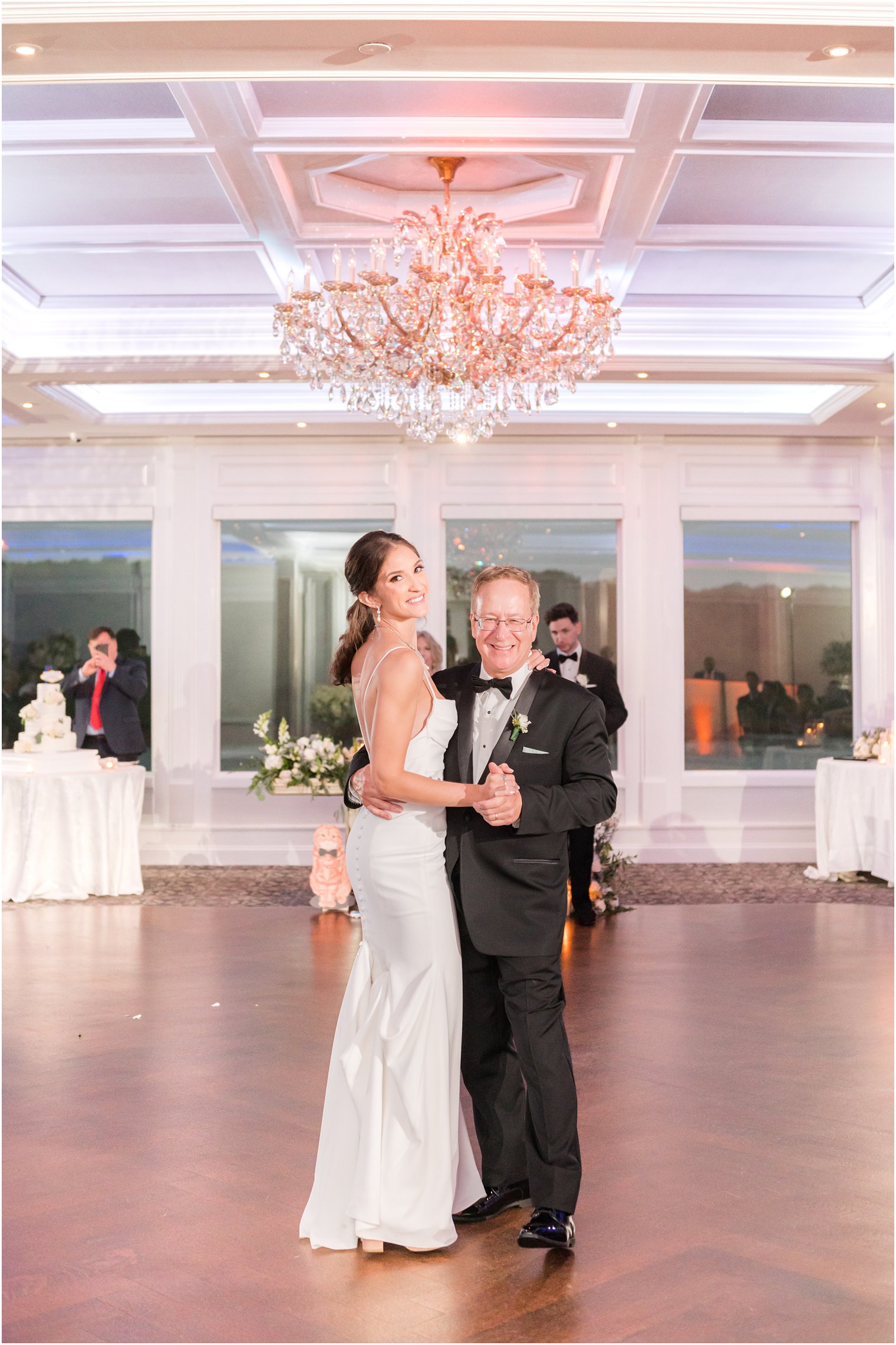 father dances with bride in ballroom at The Mill Lakeside Manor