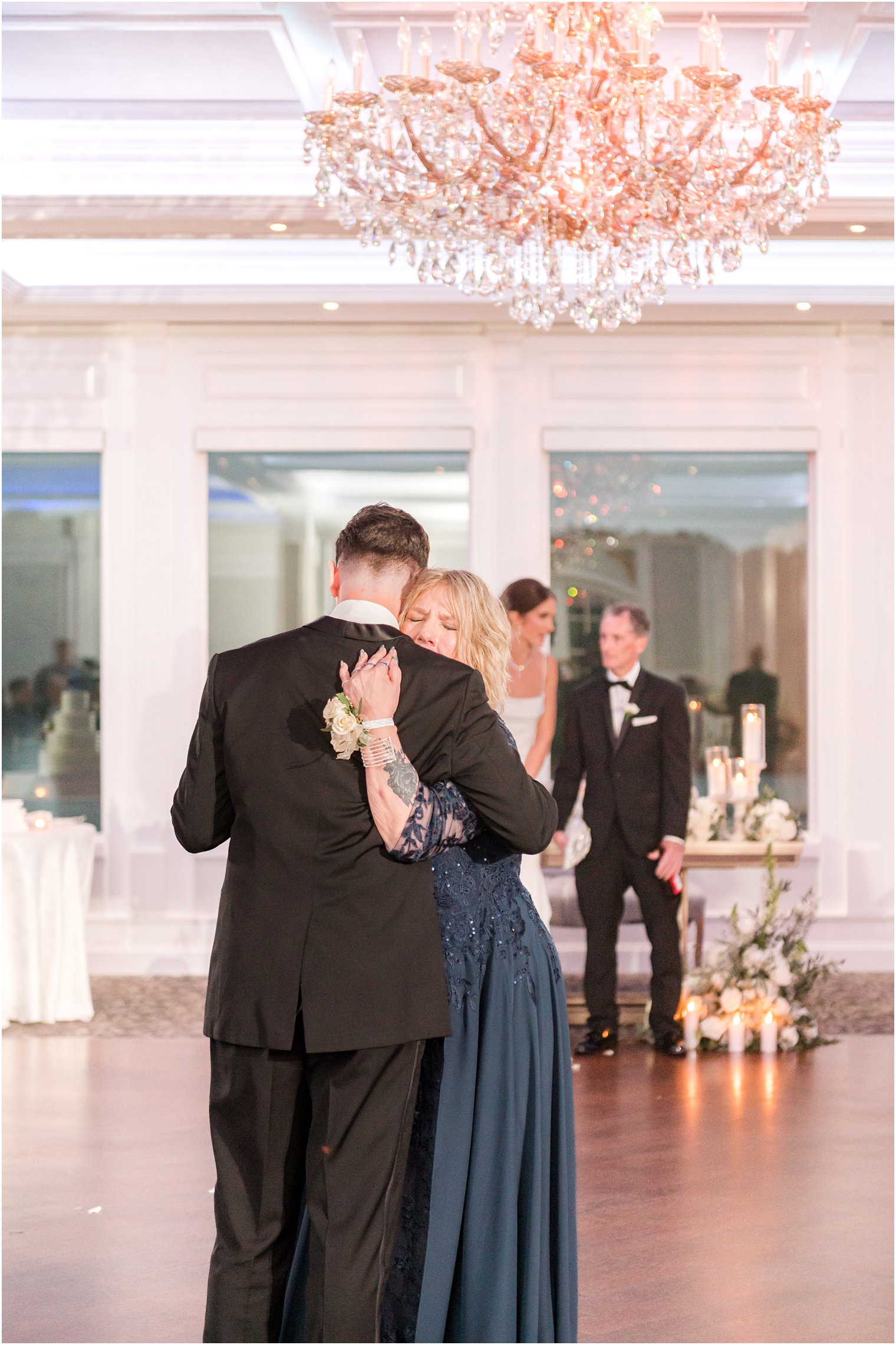 mother in navy gown hugs groom during dance at NJ wedding reception 