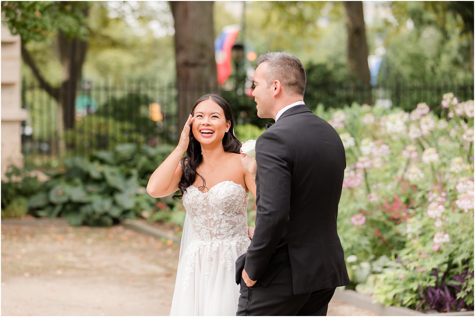 bride cries looking at groom during first look in the Rodin Museum gardens
