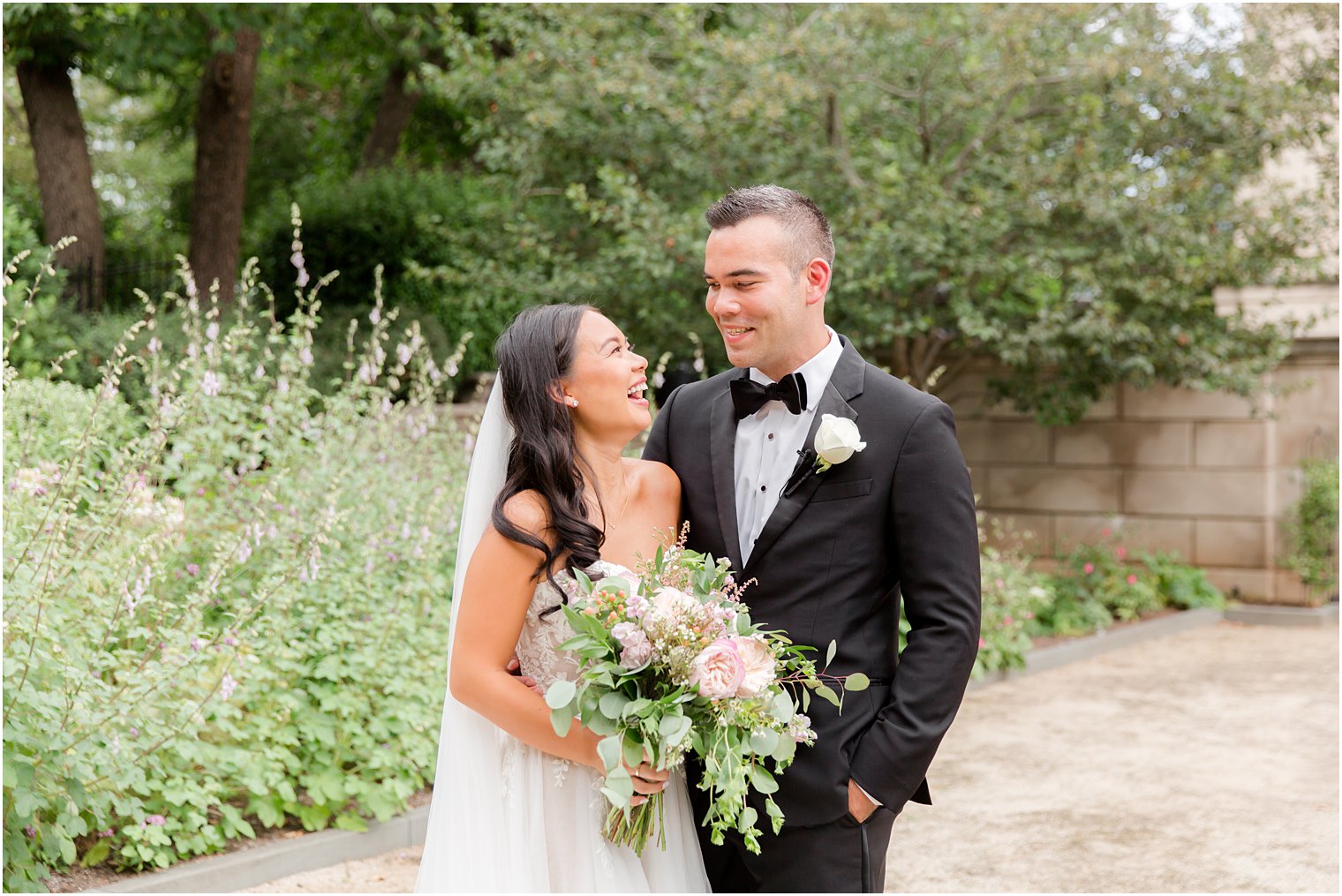 bride and groom laugh together in garden at the Rodin Museum