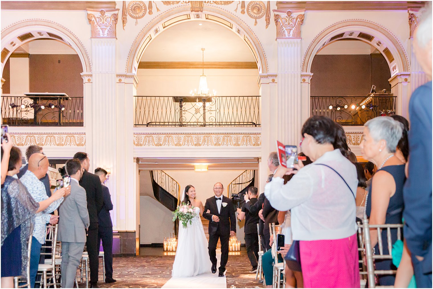 bride walks down aisle during ceremony at the Ballroom at the Ben