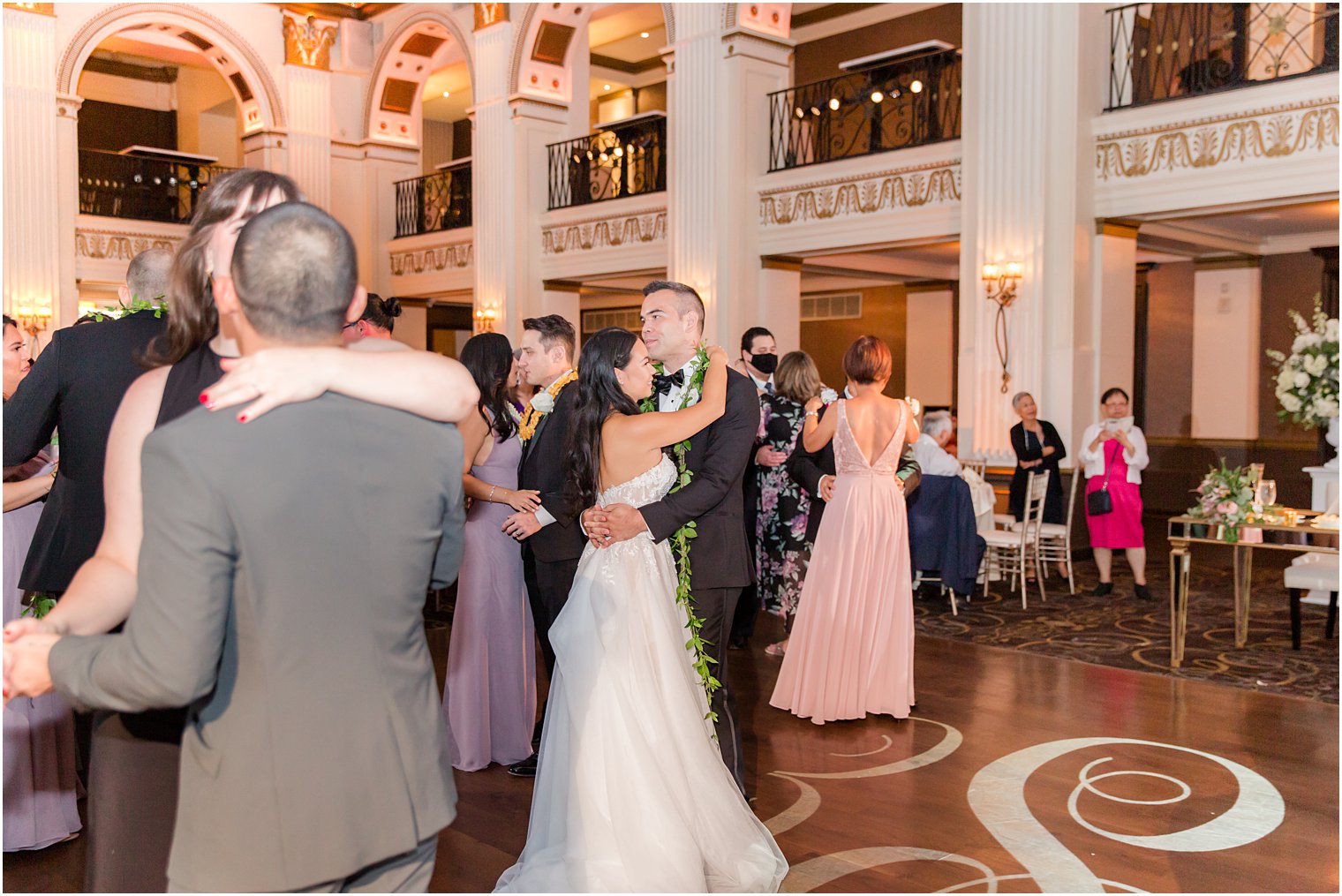 newlyweds dance with wedding guests during reception at the Ballroom at the Ben