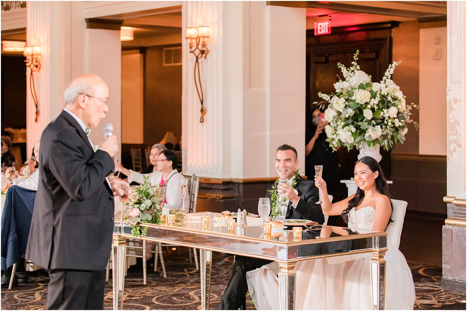father gives speech to bride and groom during wedding reception 