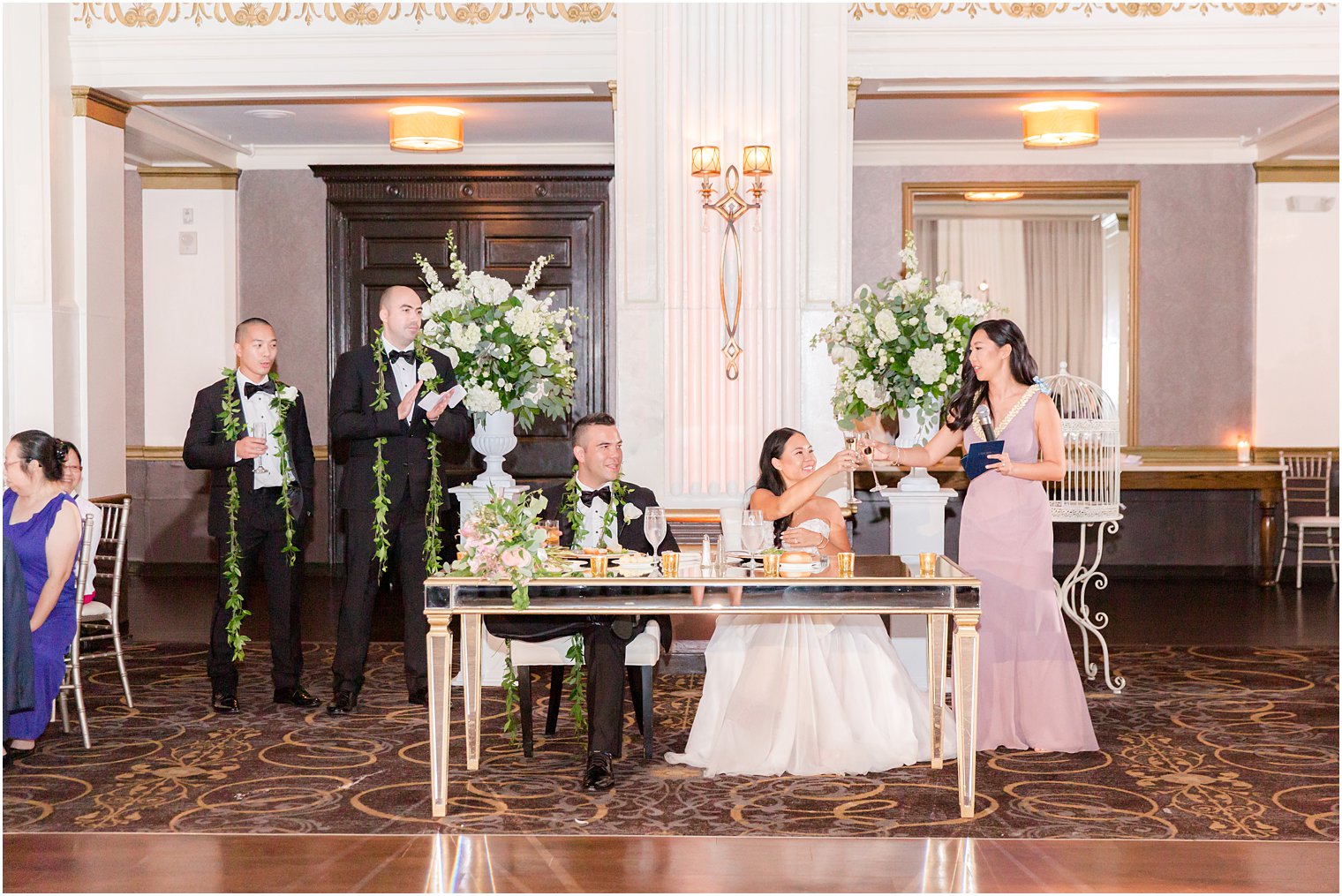 bride reads speech to bridesmaid and groom during reception at the Ballroom at the Ben