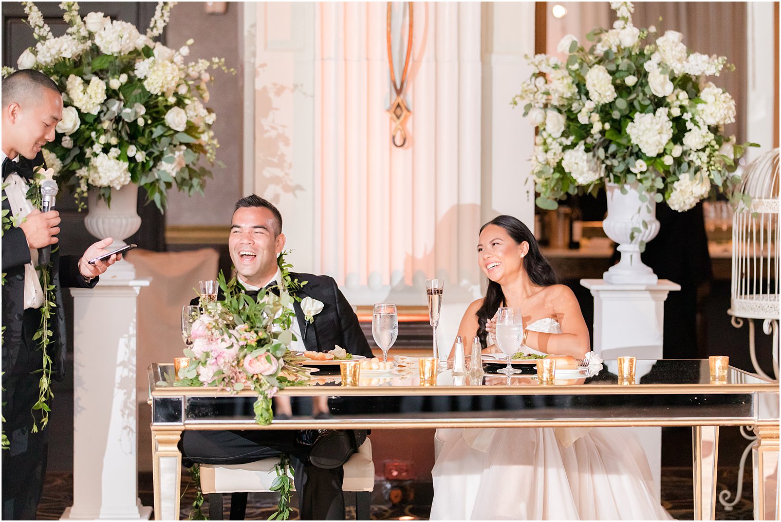 newlyweds laugh during speeches at the Ballroom at the Ben