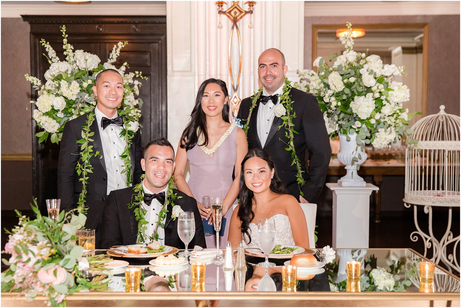 bride and groom pose with maid of honor and best men during reception 