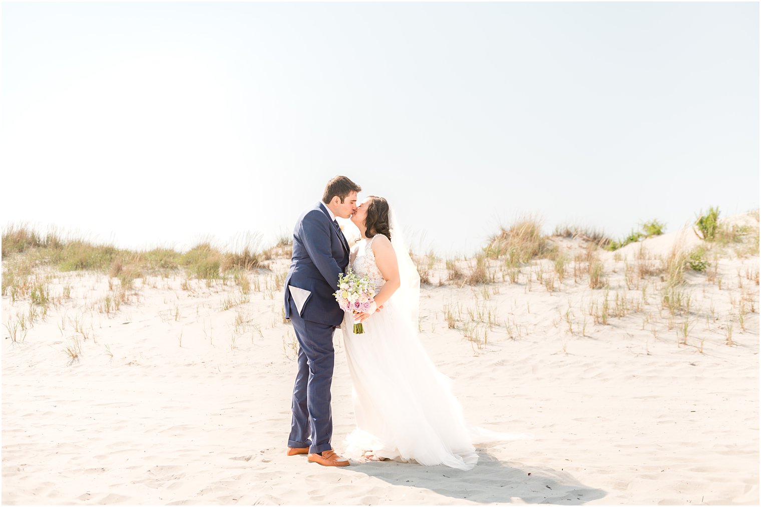 bride and groom kiss on Avalon NJ beach