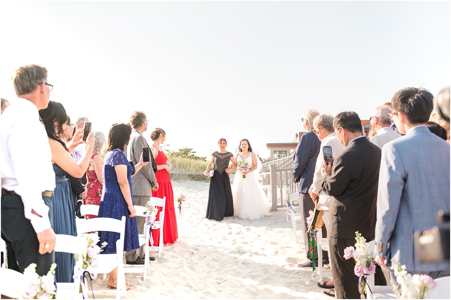 mother in black dress walks bride down aisle for beach wedding ceremony in Avalon NJ