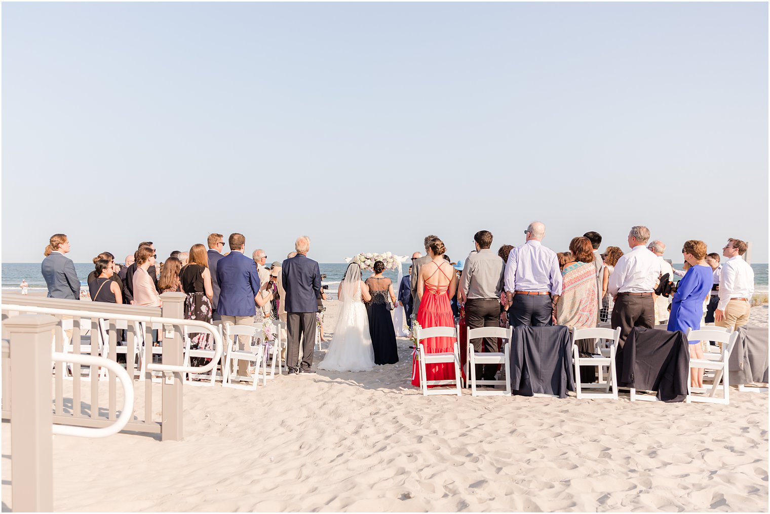 bride and mother enter beach wedding ceremony in Avalon NJ