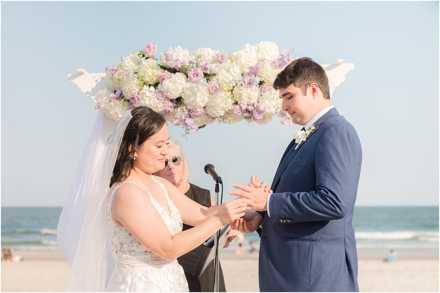 couple exchanges vows during beach wedding ceremony in Avalon NJ