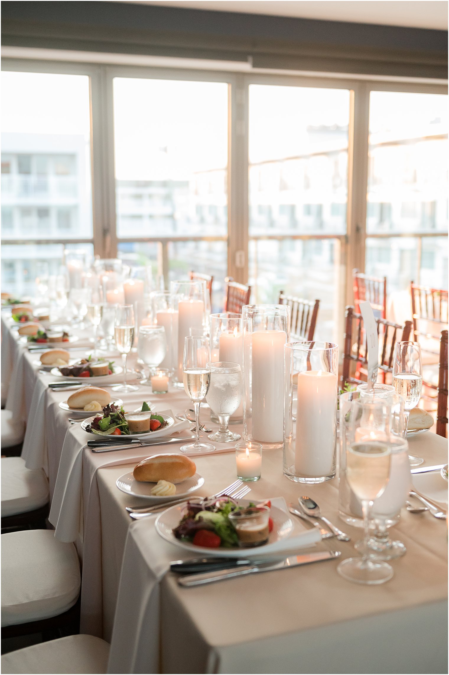 wedding reception table with tall pillar candles 