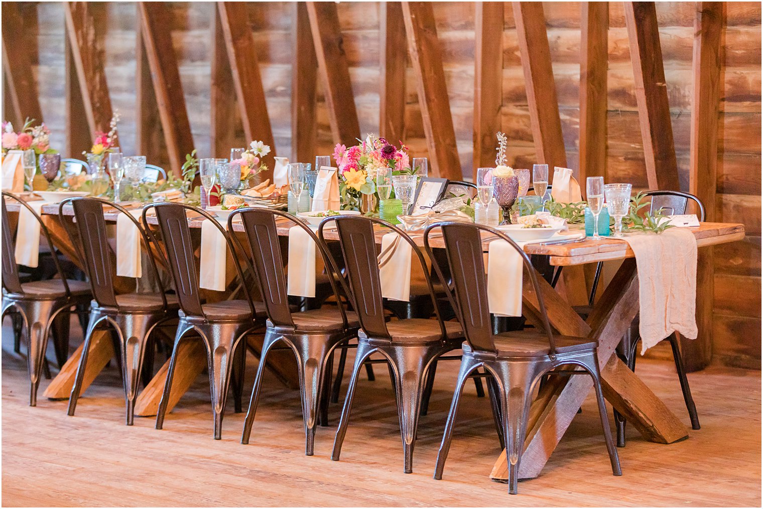 rustic wedding reception in barn at Bishop Hall Farmstead with wildflower details 