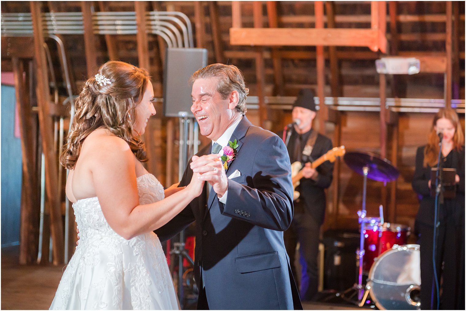 bride and father dance together during wedding reception 