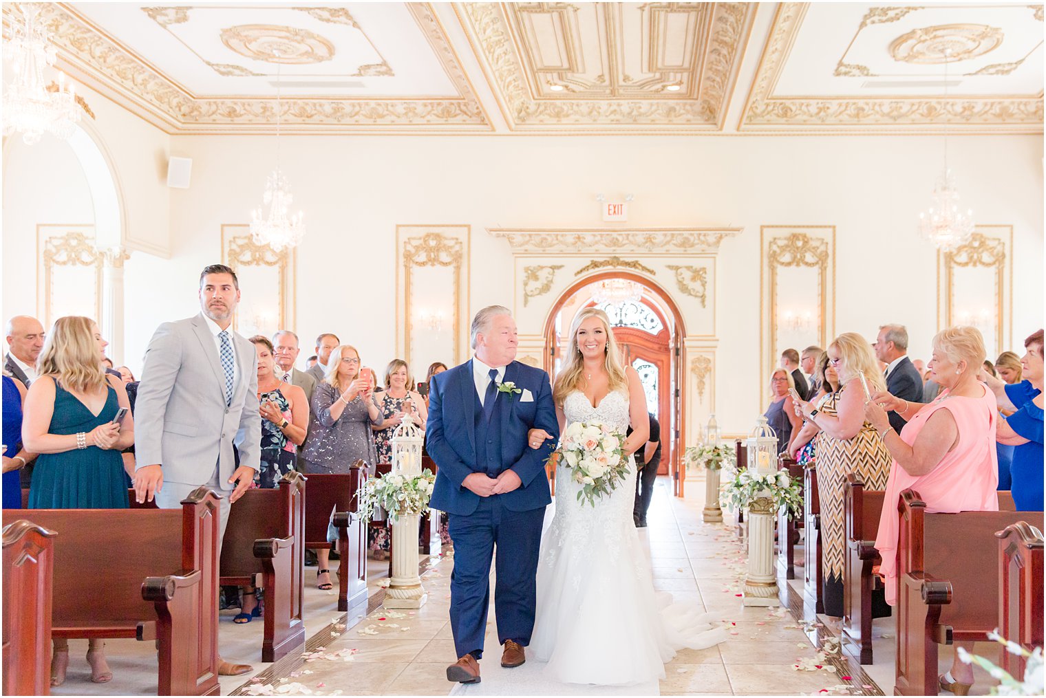 bride walks into wedding ceremony in chapel at Brigalia's with father 