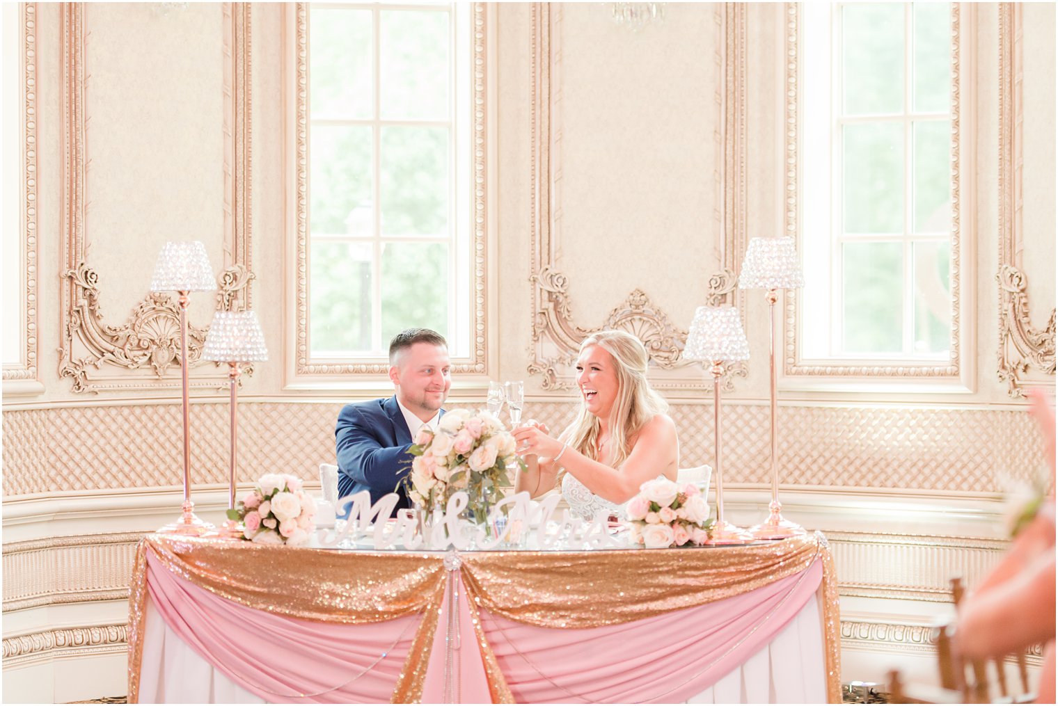 bride and groom toast champagne at sweetheart table 