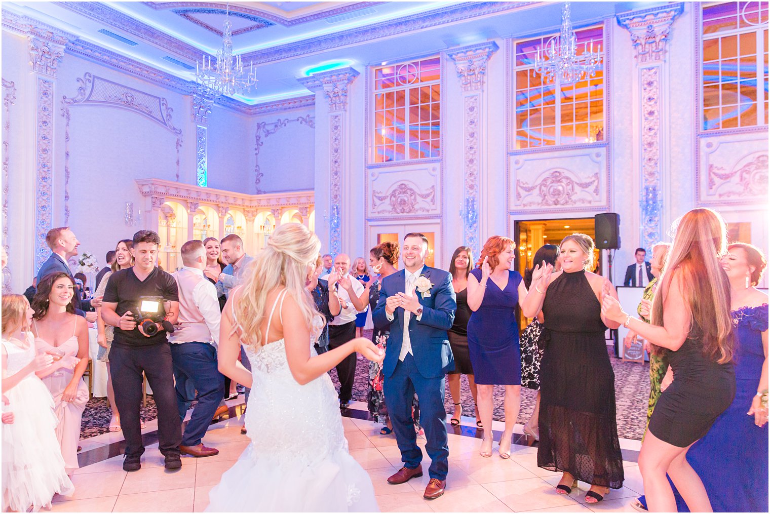 bride and groom dance with guests on floor at Brigalia's