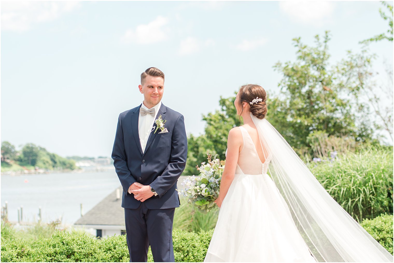 groom turns to look at bride during first look at Crystal Point Yacht Club