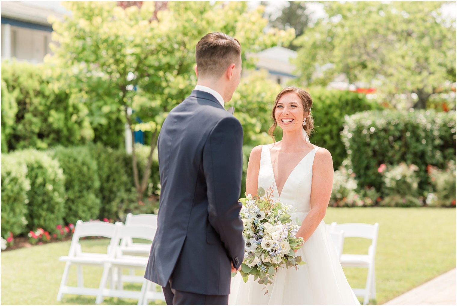 bride smiles at groom during first look at Crystal Point Yacht Club