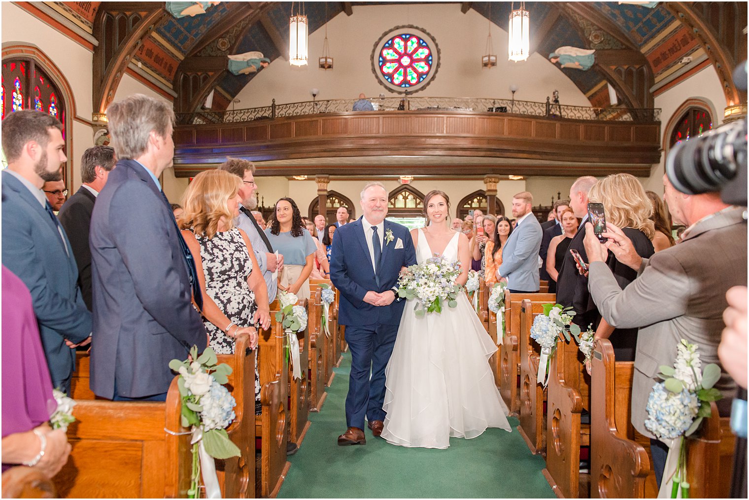 bride walks with father down aisle for traditional church wedding ceremony at St. Peter's Church