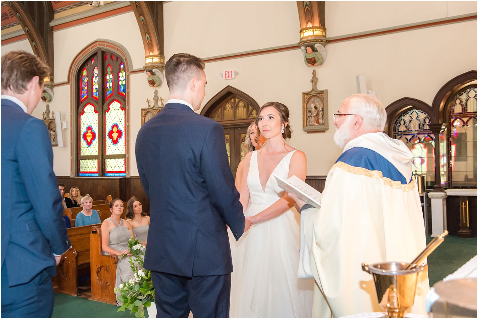 bride and groom exchange vows during traditional church wedding ceremony at St. Peter's Church