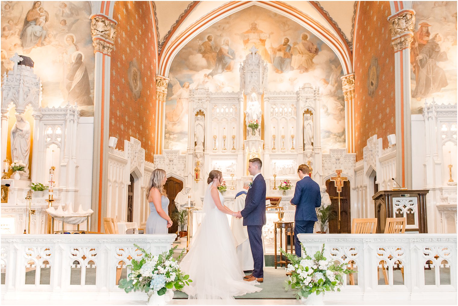 bride and groom stand exchanging vows during traditional church wedding ceremony at St. Peter's Church