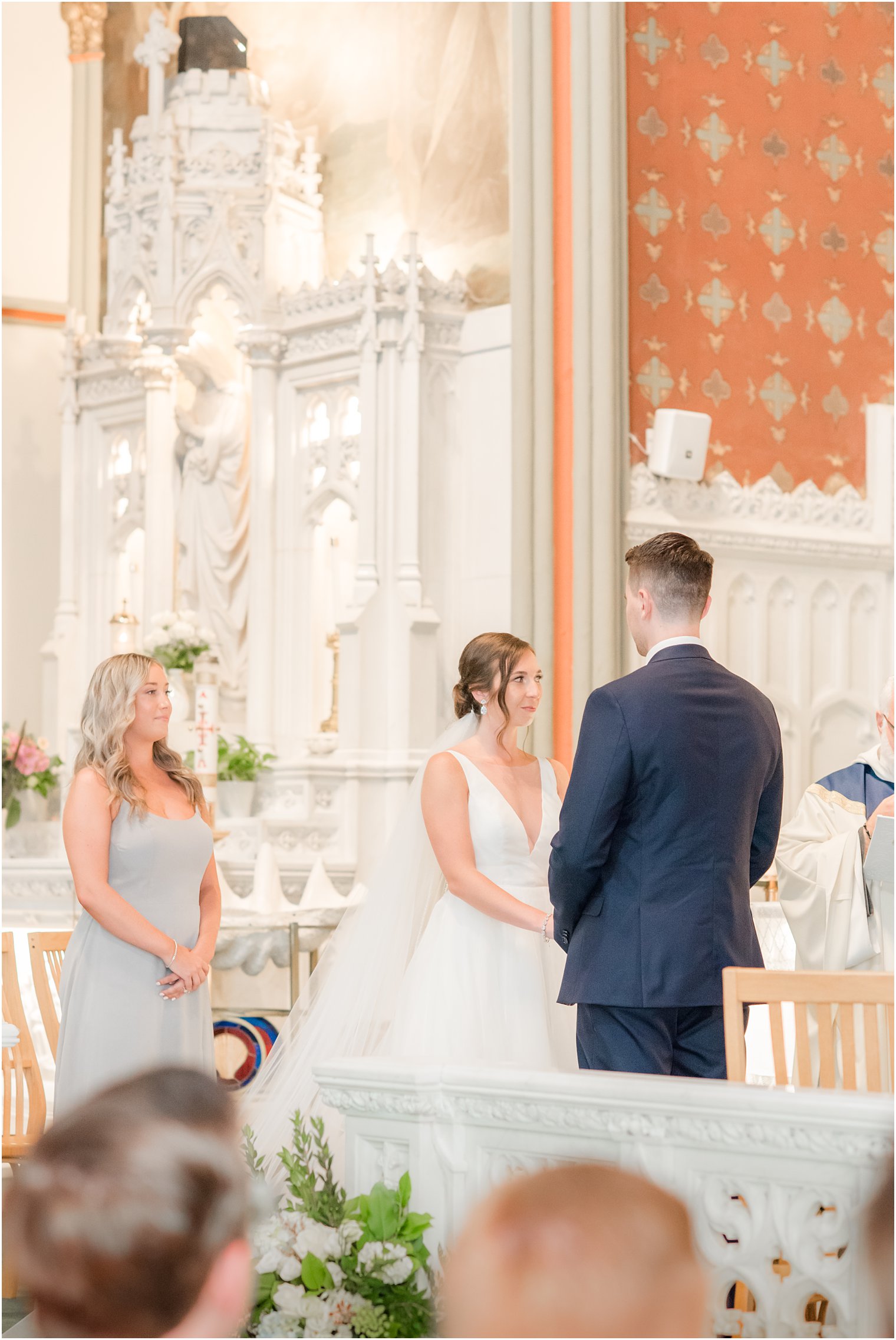 groom looks at bride during vows for traditional church wedding ceremony at St. Peter's Church