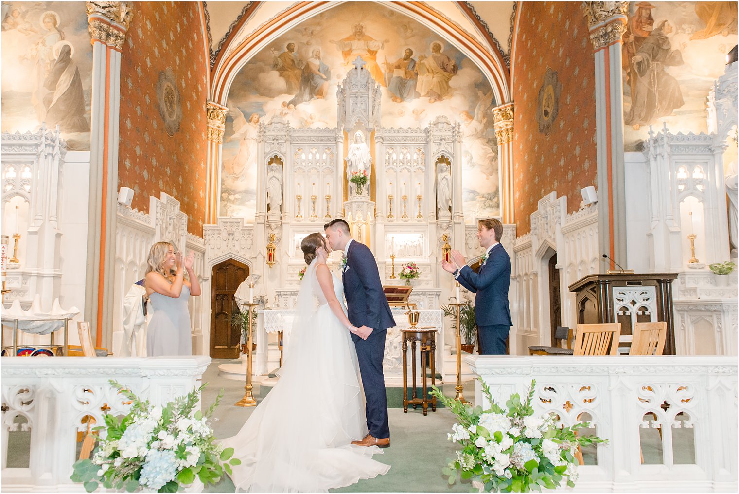 bride and groom kiss during traditional church wedding ceremony at St. Peter's Church